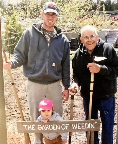 Three generations enjoy gardening together in a vibrant family garden filled with love.