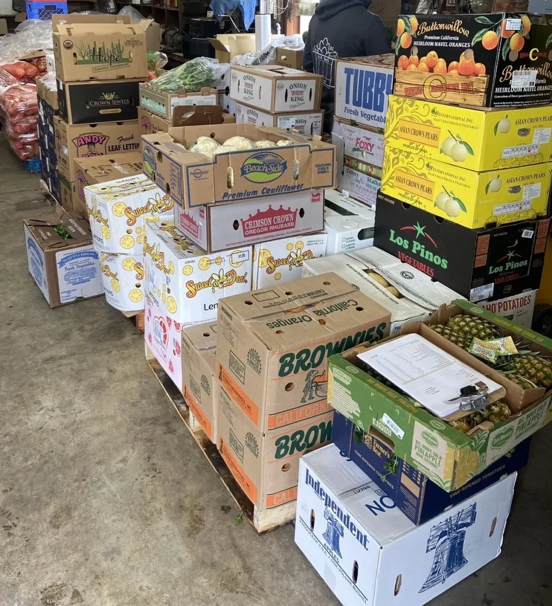 Fresh produce distribution hub with colorful boxes of fruits and vegetables ready for market.